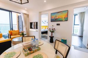 a living room with a table and chairs at The Hillside Seaview Apartment Phu Quoc in Phu Quoc