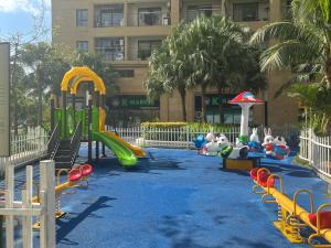a playground with slides and play equipment in front of a building at Tami Homes - Vinhomes D'Capitale Executive Apartment in Hanoi +20 photos