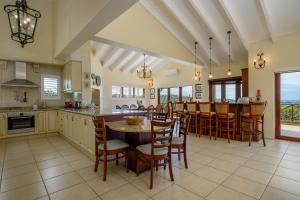 a large kitchen with a table and chairs in it at San Lameer Villa 14317 - 4 Bedroom Deluxe - 8 pax - San Lameer Rental Agency in Southbroom
