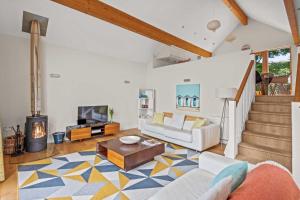a living room with a couch and a fireplace at House 32 in Looe