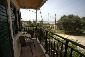 a balcony with two chairs and a table on it at Asterias in Koronisía