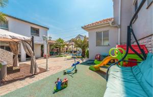 a backyard with a playground with a slide at Gorgeous Apartment In Sukosan in Sukošan