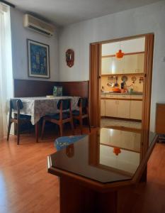 a living room with a table and a dining room at Largo in Crikvenica