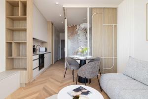 a living room with a table and a couch at Elegant Studios in Katowice with Gym, Sauna & Cinema by Noclegi Renters in Katowice +59 photos
