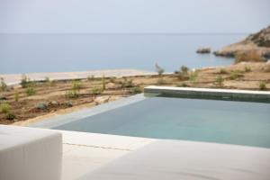 a swimming pool with a view of the beach at Cavo Marelia in Amoopi