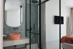 a bathroom with a shower and a sink at Cavo Marelia in Amoopi