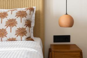a bedroom with a bed with a pillow and a lamp at Cavo Marelia in Amoopi