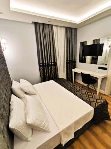 Postel nebo postele na pokoji v ubytování Luxx Garden Hotel
