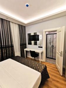 Postel nebo postele na pokoji v ubytování Luxx Garden Hotel