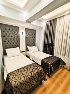 Postel nebo postele na pokoji v ubytování Luxx Garden Hotel