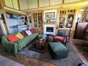 a living room with a couch and a table at Cottage Cantinho da Quinta in Vila Franca do Campo