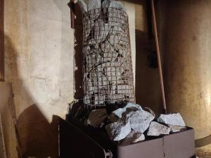 a pile of rocks in a box next to a wall at Veski talu aidamaja in Muda