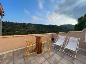 a table and chairs on a balcony with a view at La Villa 101 -TOPVACANCES -LES ISSAMBRES in Roquebrune-sur-Argens