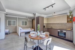 a kitchen and living room with a table and chairs at Cozy Apartment Heart of St Julians Sleeps 5 in San Pawl il Bahar