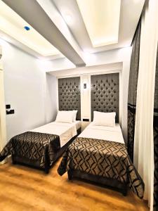 Postel nebo postele na pokoji v ubytování Luxx Garden Hotel