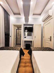 Postel nebo postele na pokoji v ubytování Luxx Garden Hotel