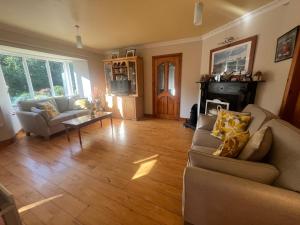 un soggiorno con un divano e un tavolo di PK Lodge Bed and breakfast a Skibbereen