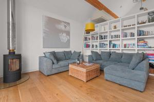 a living room with two couches and a fireplace at House 28 in Looe