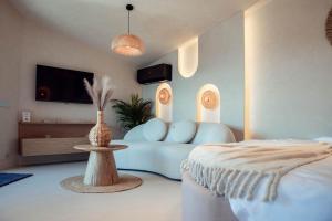 a living room with a blue couch and a table at Amumi Tiny Houses in Buhalniţa