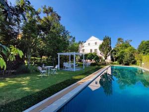 a swimming pool with a gazebo next to a house at Villa Malinee Khao Yai 6 Bedrooms Italian Private Villa in Ban Tha Chang