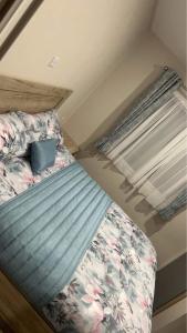 a small bed in a small room with a window at Clearwater Lodge in Lossiemouth