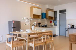 a kitchen with a wooden table and chairs in a kitchen at Serene Japandi Family Retreat 2-6 pax& Sunrise View in Brinchang