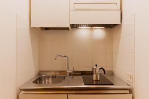 a kitchen with a sink and aaucet at Marbela Apartments & Suites in Palermo +136 photos