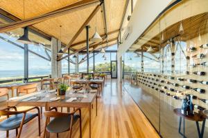 a restaurant with tables and chairs and large windows at Grootbos Private Nature Reserve in Gansbaai
