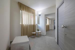 a hallway with a room with a table and a door at Jolanda Sea Breeze in Trapani