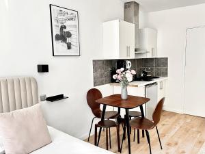 a kitchen with a table and chairs in a room at Mondétour Paris centre - Urban flat in Paris