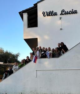 a group of people standing on the stairs of a building at Villa Lucia in Agios Georgios Pagon