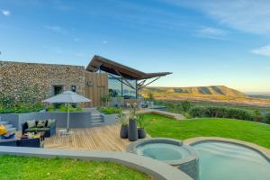 a backyard with a swimming pool and a house at Grootbos Private Nature Reserve in Gansbaai