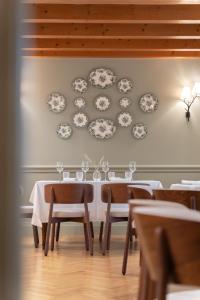a dining room with a table and plates on the wall at Fiori e Frutti Agriresort in Mestre