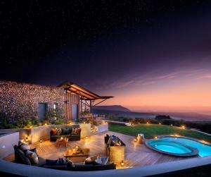 an outdoor patio with a pool at night at Grootbos Private Nature Reserve in Gansbaai