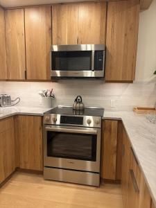 a kitchen with a stainless steel stove and a microwave at Riverside A03 condo in Telluride