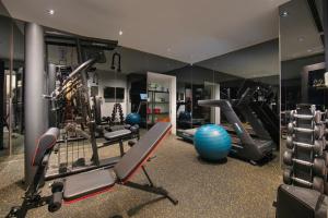a gym with several treadmills and exercise equipment at La Mejor Indochine Hotel in Hanoi