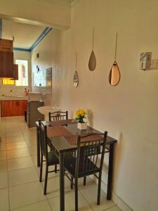 a dining room with a table and chairs in a kitchen at Ocean Breeze Apartments,Shanzu in Mombasa