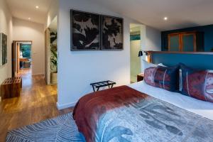 a bedroom with a king sized bed and a hallway at Grootbos Private Nature Reserve in Gansbaai