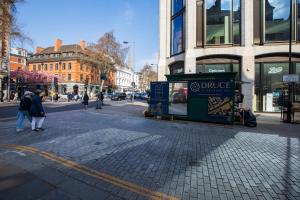 a city street with people walking down the street at Kensington Luxury Suites in London