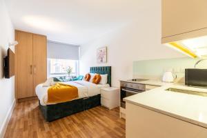 a bedroom with a bed in the middle of a kitchen at Kensington Luxury Suites in London +25 photos