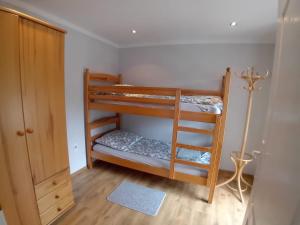 a room with two bunk beds and a closet at Domek Łagów Lubuski in Łagów