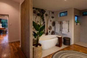 a bathroom with a bath tub with a plant in it at Grootbos Private Nature Reserve in Gansbaai