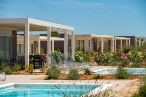 a resort with chairs and a swimming pool at Terra Park Phalaris in Novalja