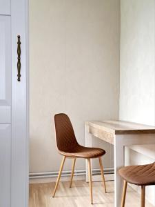 a chair and a desk in a room at White Home & Garden in Klaipėda