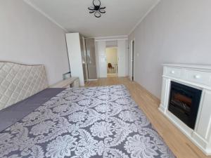 a bedroom with a bed and a fireplace at White Home & Garden in Klaipėda +33 photos