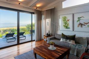 a living room with a couch and a table at Grootbos Private Nature Reserve in Gansbaai