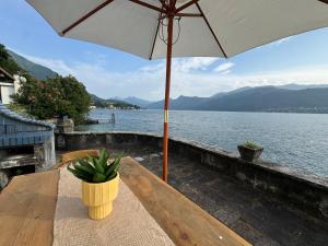 a table with an umbrella and a potted plant on it at Villa Planca by Gottschalk in Fiumelatte +115 photos