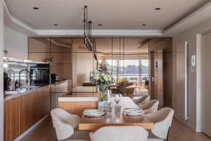 a kitchen and dining room with a table and chairs at Moon Light - A 50m de la mer in Dinard