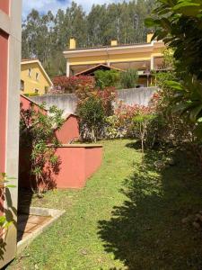 a yard with bushes and a fence and a house at Playa Ribadesella Cris in Ribadesella +4 photos