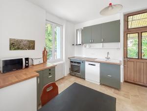 a kitchen with a sink and a microwave at Maison cosy with private garden, 4 bedrooms, Wine Route in Nuits-Saint-Georges